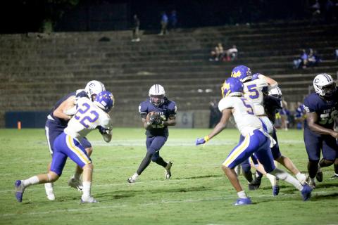 Jacari Barnett looks up-field as he carries the ball during Elbert County’s 36-27 comeback win over Washington-Wilkes in the Granite Bowl Sept. 15. Barnett led the team with 160-yards rushing and three touchdowns in the win as the Devils improved to 4-1 on the season. (Photo by Wells)