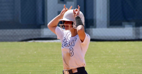 Erica Christian does the Devil sign to the Elbert County dugout after reaching base safely in Elbert County’s 17-1 win over Academy of Richmond County Sept. 30. (Photo by Bethany Booth)