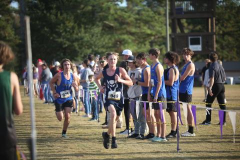 Ezra Adamson beats a Barrow runner to the finish line during the Region 8A Division 1 championship meet Oct. 26. (Photo by Wells) 