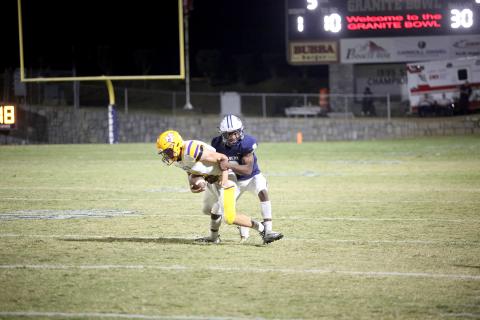 Senior Isiah Davis makes an open-field tackle on the Athens Christian quarterback. (Photo by Wells)