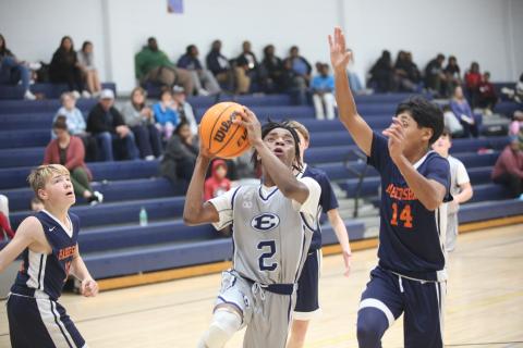 Tyler Turman splits a pair of Habersham defenders and drives to the basket Dec. 11. (Photo by Wells)