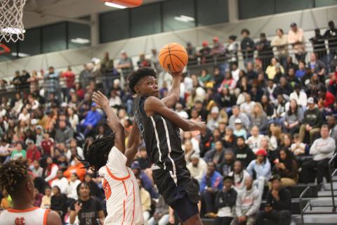 D.K. Winn floats in the air as he attempts a reverse layup in Elbert’s loss to Hart County. (Photo by Wells)