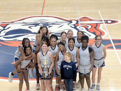 The seventh grade Lady Rams team poses with their championship trophy after defeating Madison County 34-30 Jan. 20. (Photo courtesy of Donna Baker))