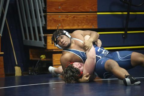 M.J. Cook pins an opponent during his first match of the Inferno Invitational Jan. 27. Cook was among a group of five Devils who finished in second during the event. (Photo by Wells)