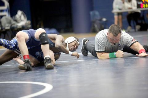 The referee slaps the mat as Bry Harper pins an opponent during Elbert’s dual against Johnson Jan. 17. (Photo by Wells)