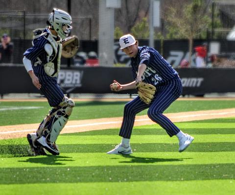 No. 26 Landon Adams gathers the ball and throws to first as Camden Bryant looks on during the GA Dugout Club Tournament. (Photo courtesy of April Dixon Hughes)