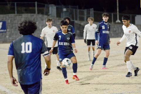 No. 7 Pablo Medellin settles the ball while No. 16 Brandon Horne and No. 10 Juan Martinez look on during Elbert’s 9-1 win over Hart County Feb. 9. (Photo by Benjamin London of The Hartwell Sun.)