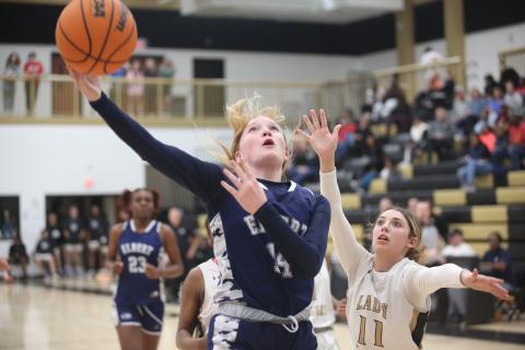 Audrey Lunsford gets by a Commerce defender and lays in an acrobatic layup during the Lady Devils loss to Commerce Feb. 2. (Photo by Wells)