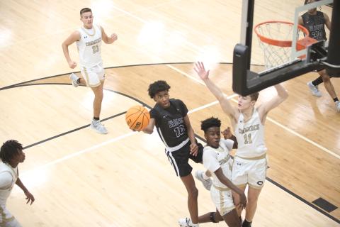 A.J. Brown takes on two defenders and lays the ball in at the end of a fast break during Elbert County’s 59-55 win over Commerce Feb. 2. Brown led the team in scoring with 14 points. (Photo by Wells)