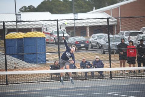 Ty Johnson serves the ball during Elbert’s first home match of the season against Clarke Central Feb. 8. (Photo by Wells)