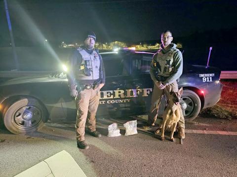 Pictured following a traffic stop turned drug bust of 4.5 pounds of methamphetamine laced with fentanyl, with an estimated street value of $200,000 are (L-R) Sg. Noah Hart and Lt. Jorge Hernandez with canine officer Maiko. (Photo courtesy of the Elbert County Sheriff’s Office)