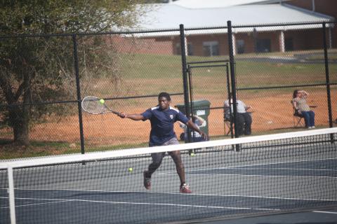 Jasean Jenkins charges the net during his win in the boys No. 1 doubles match against Hart. (Photo by Wells)