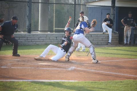 Brooks Banks slides past the Oglethorpe catcher and reaches for the plate as he scores a run for the Diamond Devils in their 10-0 win over the Patriots March 21. Banks finished the game with a home run, two hits, two runs and two RBIs. (Photo by Wells)