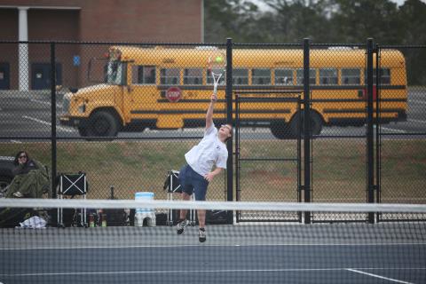 Adrian Jenkins serves the ball during his 9-7 win over his Hart County opponent in the No. 1 singles match. (Photo by Wells)