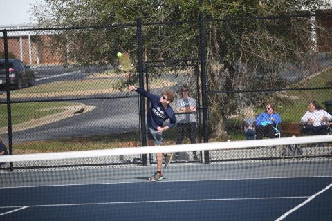 Mitchell Wheeler serves the ball during the Devils 3-2 win over Barrow Arts and Sciences Academy March 11. (Photo by Wells)