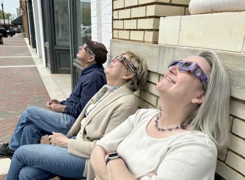 Members of The Elberton Star staff (right, L-R) Earl Saxon, Valerie Evans and Barbara Slay enjoyed viewing the eclipse (left) with safety glasses. (Photo by Scoggins) 
