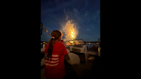 McKenzi Kesler watches the sky light up during the Soap Creek fireworks display while her dad, Larry, captures her reaction on his. 