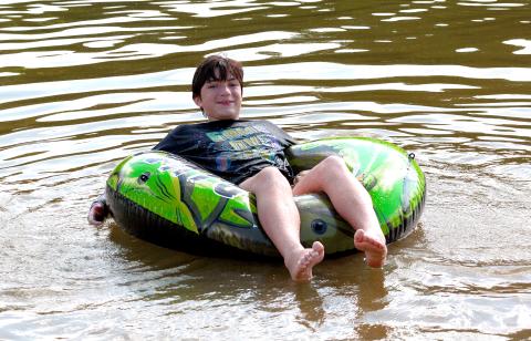 Elberton resident Asher Hanson enjoys beating the heat in the somewhat tepid lake water along with his sister, Isabelle, and their friends and family while visiting Lake Russell State Park Saturday, June 29. 