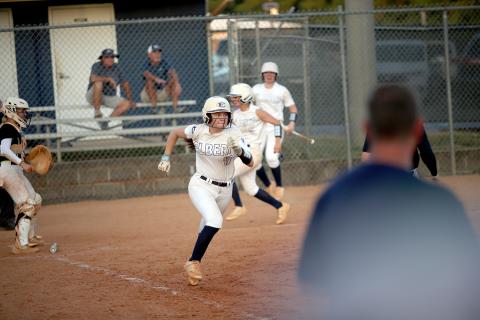 Hannah Brady sprints towards first base after laying down a bunt. (Photo by Wells)