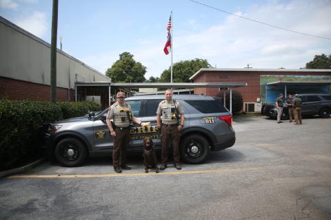 (Above L-R) Lieutenant Allen Frady, K-9 officer Remi and Sergeant Clete Brady display the methamphetamine recovered during a recent drug bust made by the Elbert County Sheriff's office. (Photo by Wells)