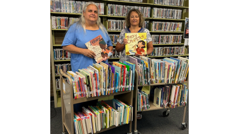 Elbert County Librarian Jan Burroughs and Elbert County School L4GA Coordinator Thesa  Beatenbough display some of the 260 titles purchased for the library by the school district’s L4GA grant to fund literacy in Elbert County. (Photo submitted by Jan Burroughs)