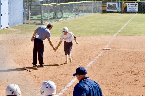 Kamryn Webb high fives Head Coach Bryce Bowen after hitting a three-run home run in Elbert’s second game against Dodge County Oct. 19. (Photo courtesy of Elbert County True Blue)