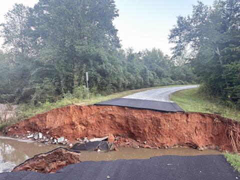 The rate at which water fell Thursday into Friday morning caused several areas of roads to fail including this 35-foot wide washout in the Moore Road/Craft Road area in the Rock Branch community. (Photo submitted by Monica Vickery)