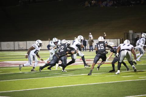 Quarterback Jayvyn Hickman runs through a mass of arm tackles during Elbert’s 26-24 win over Heard County Nov. 22. With the win the Devils advanced to the Elite Eight of the GHSA State Playoffs for the second year in a row. (Photo by Wells)