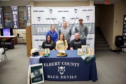 Lady Devil softball player Emily Booth signed her letter of intent to join former Elbert County softball Head Coach Drew Greer and play college softball at Piedmont University Dec. 16. Pictured with Booth during the signing ceremony are (front row, L-R) Bethany Booth, Emily Booth, Greg Booth and (back row, L-R) Faith Burgamy, Josh Jones and Bryce Bowen.