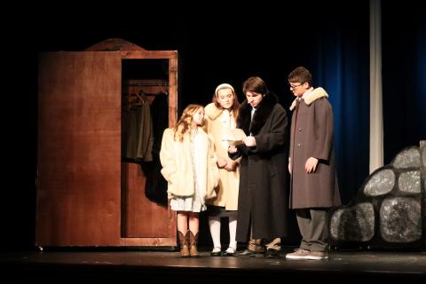 Lucy (Lyla Kate Johnson), Susan (Adrianna Pennington), Peter (Jake Triplett) and Edmund (Parker Jenkins) examine some mysterious instructions after entering Narnia via the wardrobe. (Photo by Weeks)