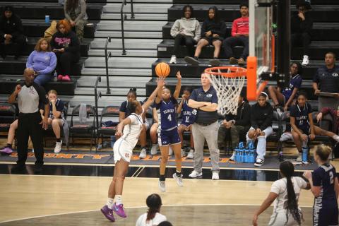 Kaylen Rucker puts up a three pointer while Head Coach Josh Jones looks on. (Photo by Wells)