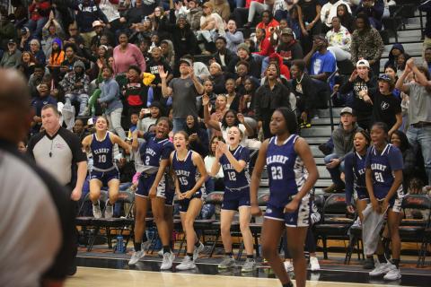 The Lady Devils bench celebrates a point while No. 23 Zy Belcher flexes. Belcher and the Lady Devils are 3-0 on the season after Elbert dominated Washington-Wilkes in the Inferno Nov. 30. (File photo by Wells)