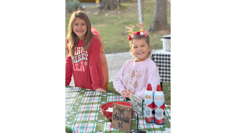 Brylee (L) and Bria (R) Dickerson set up a hot chocolate stand in their neighborhood Dec. 7 and raised over $1,000 for a needy family. (Photo submitted by Brooke Dickerson)