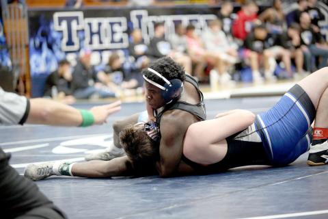 Kingston McIntosh pushes his opponents’ shoulders to the mat as he works on a pin during Elbert’s 81-0 thrashing of Fannin County in the first round of the Area 8A Championship Duals. (Photo by Wells)