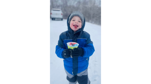 Chandler Truitt enjoys a homemade snow cone with freshly-fallen snow while playing on Springdale Drive during the Jan. 10 Snow Day. (Photo submitted by Kathy Jossey)