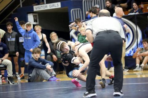 Cruz Floyd pulls his opponent to the mat with the help of a headlock during the area traditional championships. (Photo by Wells)