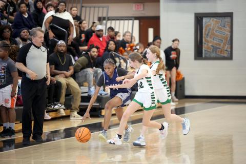 Lisa Hill dribbles past a Franklin County double team during the NEGIAA seventh-grade region championships hosted by Hart County Feb. 1. Hill led the Lady Rams in scoring with 16 points. (Photo by Wells)