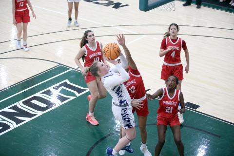 Audrey Lunsford goes up to the basket with a hand in her face Feb. 14. (Photo by Wells)