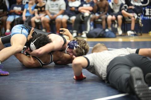 Brycin Hughes looks at his opponent’s shoulders as he rolls them onto the mat to finish off a pin. Hughes is one of seven Elbert wrestlers who qualified for the upcoming GHSA Traditional State Championship meet. (File photo by Wells)