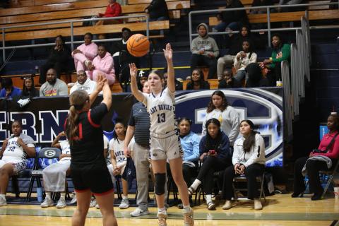 Sarah Blackmon puts up a three-pointer while the Lady Devil bench looks on. (File photo by Wells)