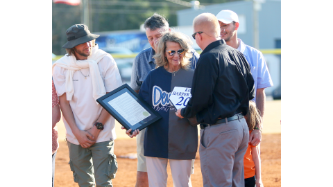 Kim Bray (center) accepts the proclamation and base award from principal Josh Rider signifying the retiring of her ECCHS jersey  while Cole Bray, Tim Bray and Chaz Bray look on. (Photo by Wells)