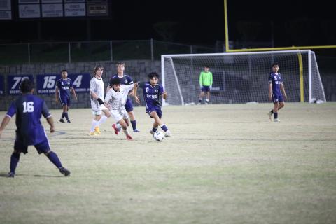 Andres Paita dribbles by a Commerce defender. (Photo by Wells)