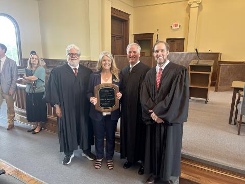 Elbert County Clerk of Courts Leigh Starrett was presented with the Liberty Bell Award by the Elberton Bar Association during a special session of the Court of Appeals of Georgia at the Elberton Courthouse. Pictured with the award are (L-R) Court of Appeals Presiding Judge Christopher J. McFadden, Starrett, Judge Kenneth Hodges III and Judge Trea Pipkin. (Photo by Wells)