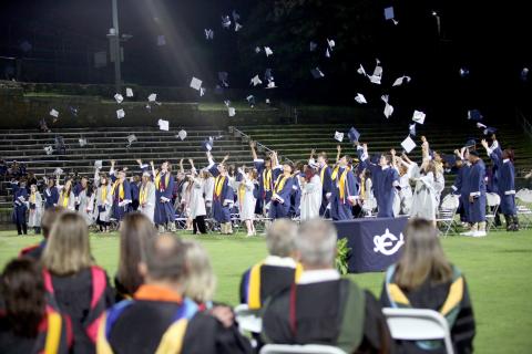 The Elbert County Comprehensive High School Class of 2025 throws their graduation caps in the air after Superintendent Robert Wheeler declares their graduation from high school education. (Photo by Wells)
