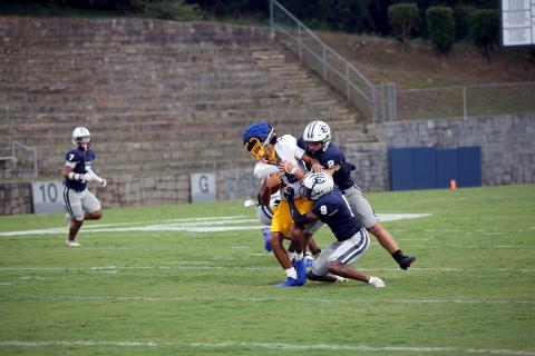 No. 2 Lincoln Blackmon and No. 9 Braylen Huff bring down the Washington-Wilkes quarterback during Elbert’s win in a scrimmage against the Tigers Aug. 1. (Photo by Bo Underwood)