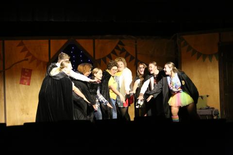 Performers of "Puffs or Seven Increasingly Eventful Years at a Certain School of Magic and Magic" huddle together during a performance at the Elberton Arts Center on August 7. (Photo by Mark Wells)