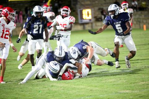 A host of Blue Devils brings down the ballcarrier in Elbert’s 24-17 loss to Lincoln on Sept. 12. (Photo by Bo Underwood)