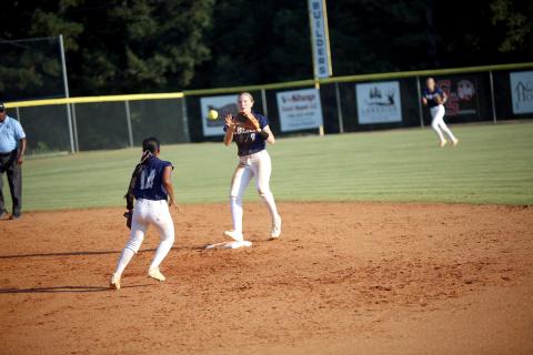 Elbert County teammates Kimberly Hernandez (14) and Audrey Lunsford (9) execute a force out in the Lady Devils’ 10-2 win over Providence Christain on Sept. 23. (Photo by Bo Underwood)