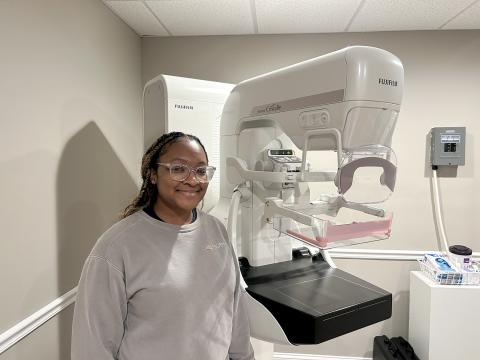 Mammography technician Alayjah Sammons poses with the Fujifilm ASPIRE Cristalle, a state-of-the-art mammography machine that is available for patients at Elbert Memorial Hospital. 