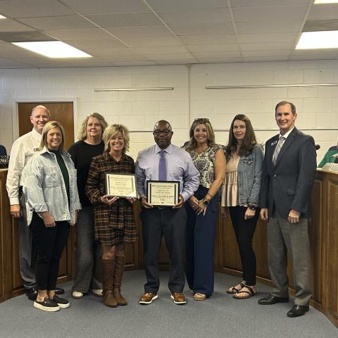 Elbert County Primary School principal Christy Hart and Elementary School principal Jasper Huff accept certificates from the board of education for their schools being designated as Title I reward schools. (Photo by Bo Underwood)